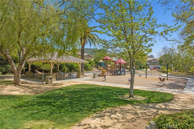 view of home's community featuring a playground, a gazebo, and a yard