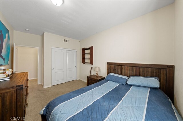 bedroom with light colored carpet and a closet