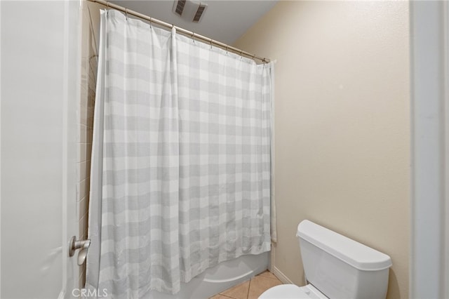 bathroom with toilet, tile patterned flooring, and shower / tub combo with curtain