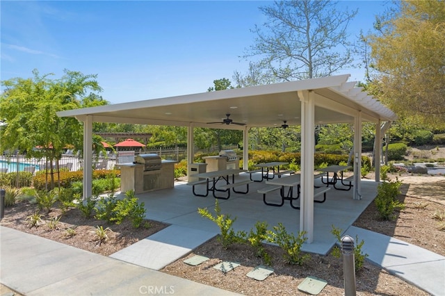 view of community featuring exterior kitchen, fence, and a patio