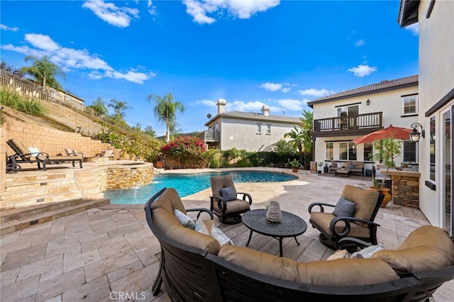 view of swimming pool featuring pool water feature, an outdoor living space, and a patio area