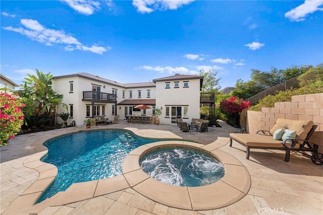 view of swimming pool with an in ground hot tub and a patio