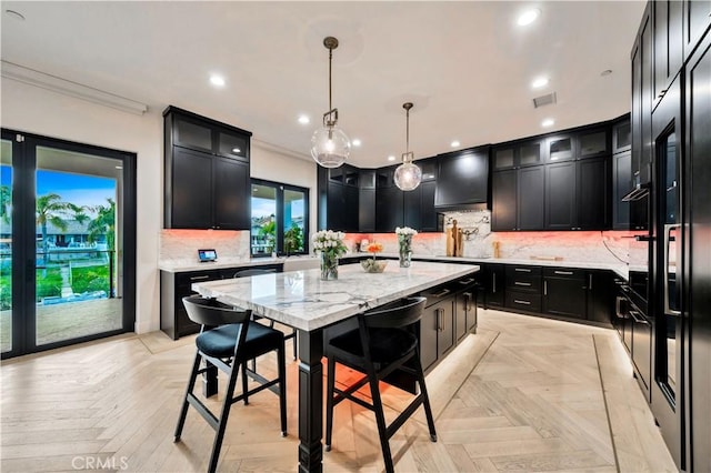 kitchen featuring a kitchen island, custom exhaust hood, recessed lighting, ornamental molding, and dark cabinets