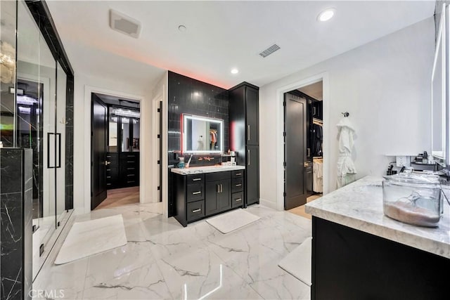 bathroom featuring vanity, recessed lighting, visible vents, and marble finish floor