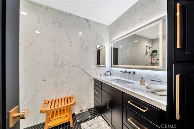 bathroom featuring vanity and tile walls