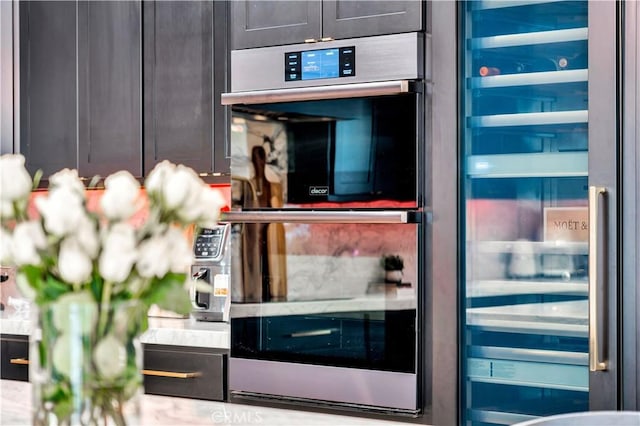 interior space with stainless steel double oven and wine cooler