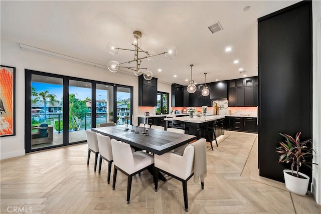 dining space featuring baseboards, recessed lighting, visible vents, and a chandelier