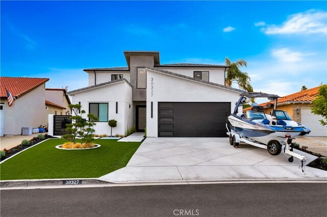 view of front facade with a front yard and a garage