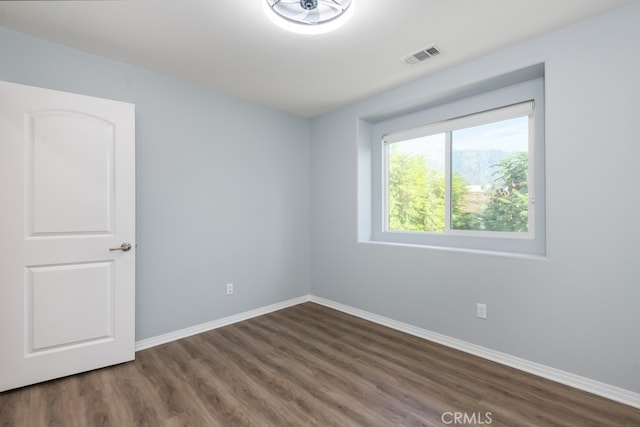 empty room with dark wood-type flooring