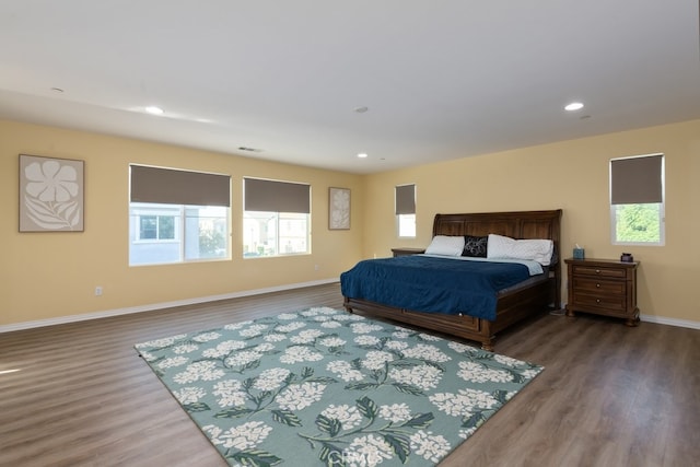 bedroom with dark hardwood / wood-style floors