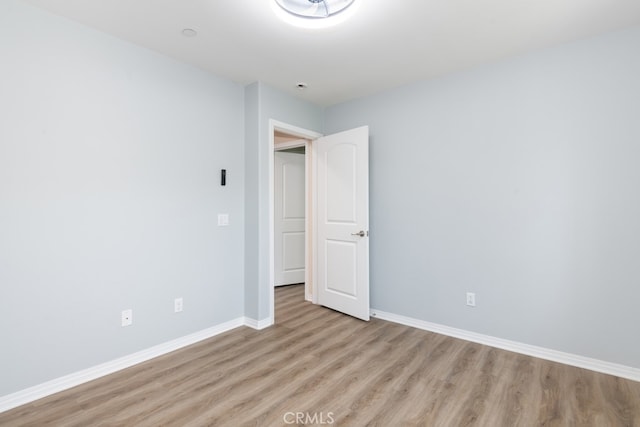 spare room featuring light hardwood / wood-style flooring