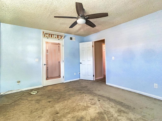 unfurnished bedroom featuring a textured ceiling, carpet flooring, and ceiling fan