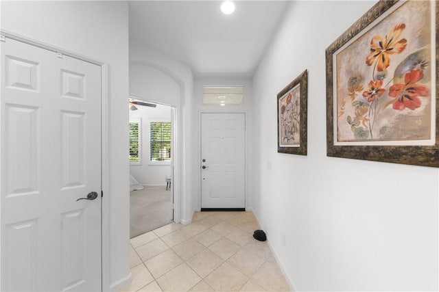 hall featuring light tile patterned floors