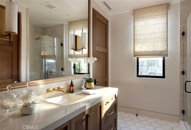 bathroom featuring vanity and a shower with shower door