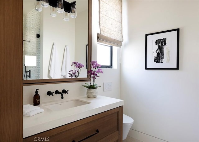 bathroom featuring vanity, toilet, and a shower with shower door