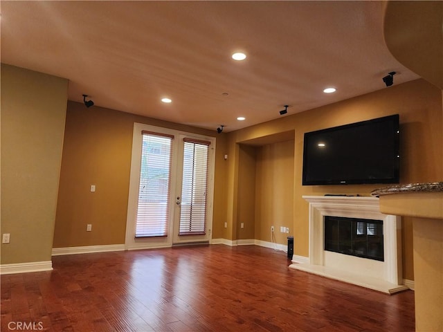 unfurnished living room featuring dark hardwood / wood-style flooring