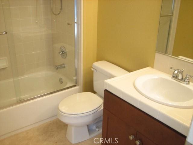 full bathroom featuring toilet, vanity, and shower / bath combination with glass door