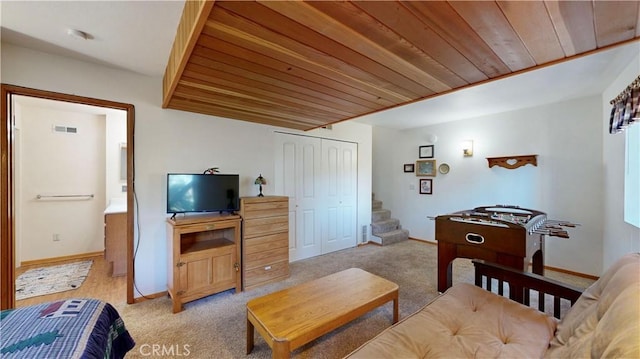 carpeted living room featuring wood ceiling