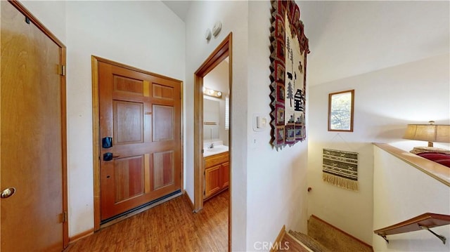 corridor featuring light hardwood / wood-style floors and sink