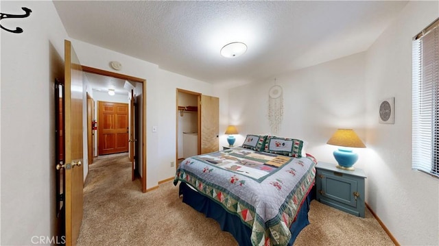 bedroom featuring a closet, light carpet, and multiple windows