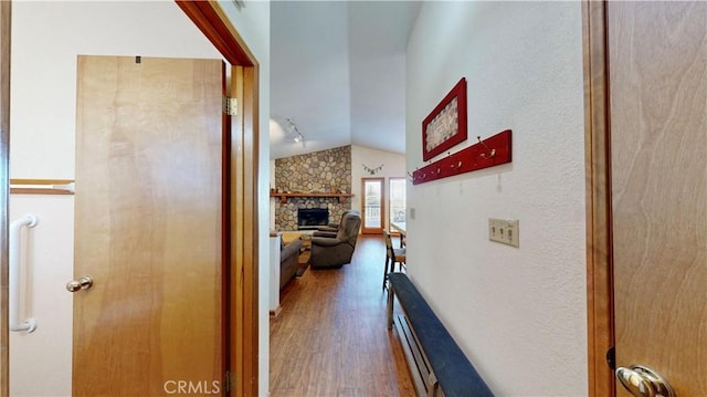 hallway with dark hardwood / wood-style floors and vaulted ceiling