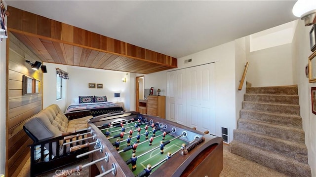 rec room with carpet and wooden ceiling