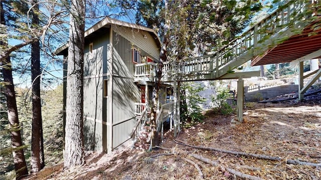 view of property exterior with a wooden deck