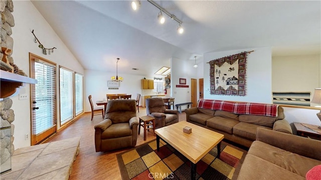 living room with light hardwood / wood-style flooring and lofted ceiling