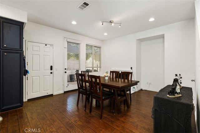 dining area featuring dark wood-type flooring