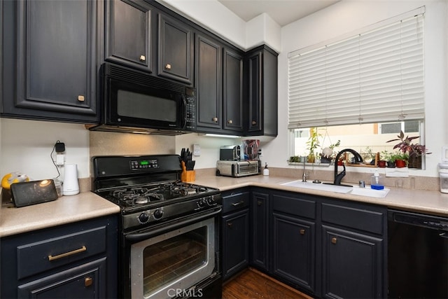 kitchen with black appliances, sink, and dark hardwood / wood-style flooring