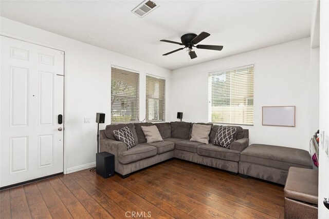 living room featuring ceiling fan, plenty of natural light, and dark hardwood / wood-style floors