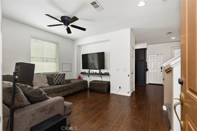 living room featuring dark hardwood / wood-style floors and ceiling fan