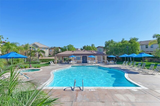 view of swimming pool with a community hot tub and a patio area