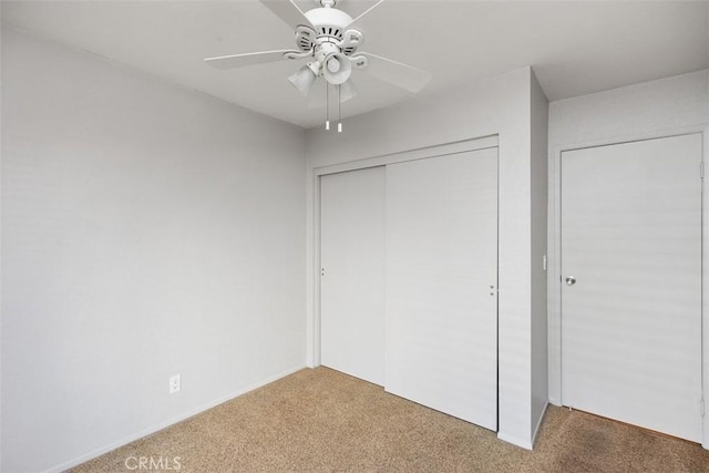 unfurnished bedroom with ceiling fan, carpet floors, and a closet