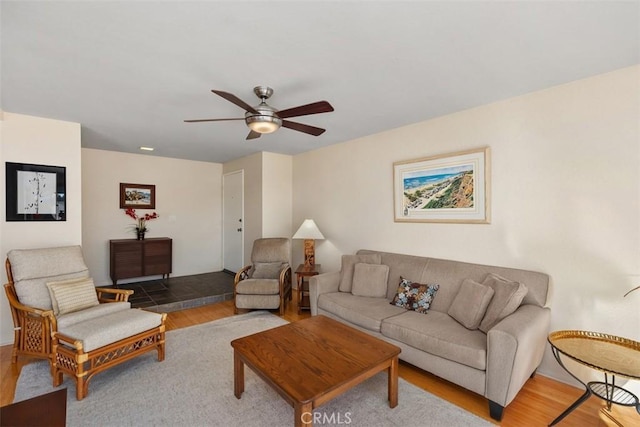 living room with ceiling fan and wood-type flooring