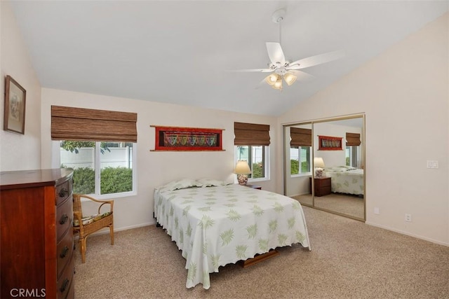 bedroom with light carpet, a closet, vaulted ceiling, and ceiling fan