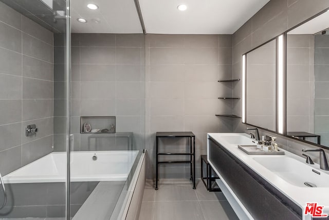 bathroom featuring vanity, tile patterned floors, and tile walls