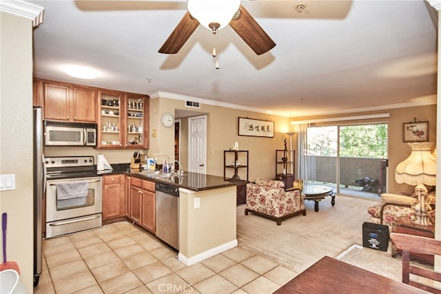 kitchen featuring ornamental molding, kitchen peninsula, stainless steel appliances, and light tile patterned floors