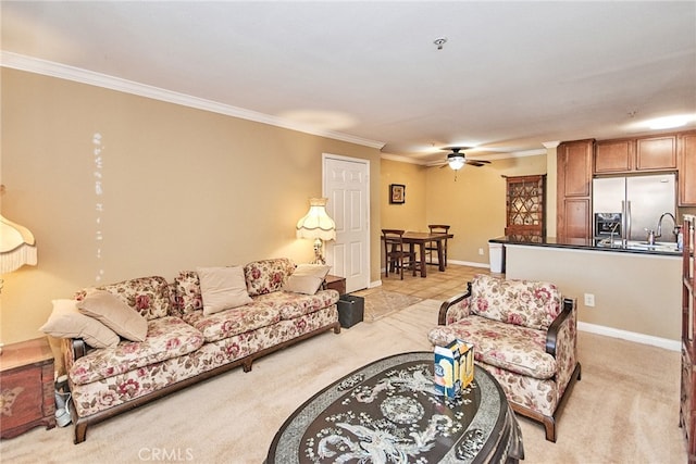 living room featuring crown molding, light colored carpet, and ceiling fan