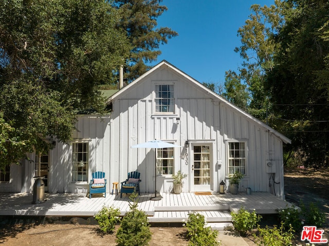 rear view of property with a wooden deck