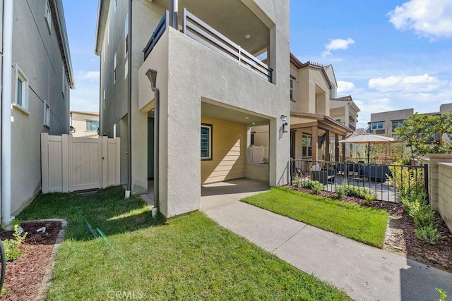 exterior space with a front yard and a patio area