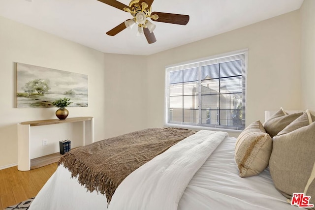 bedroom featuring ceiling fan and wood-type flooring