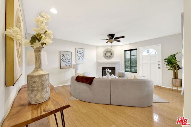 living room with ceiling fan and hardwood / wood-style floors