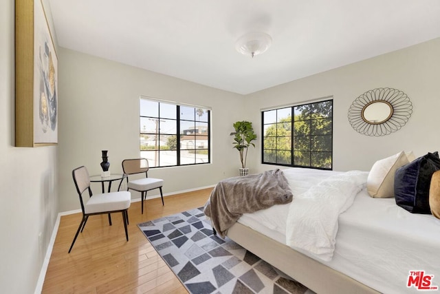 bedroom with wood-type flooring