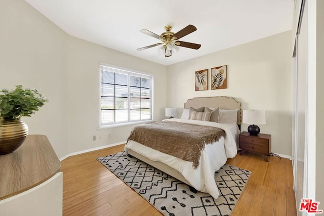 bedroom featuring ceiling fan and light hardwood / wood-style flooring