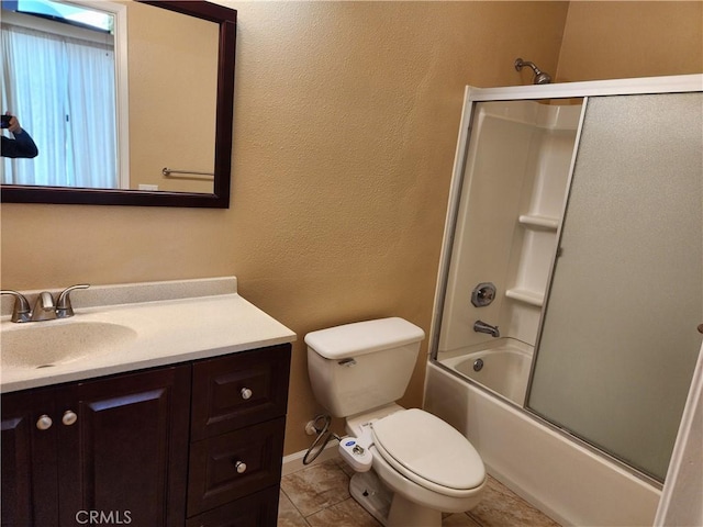 full bathroom with toilet, vanity, shower / bath combination with glass door, and tile patterned flooring