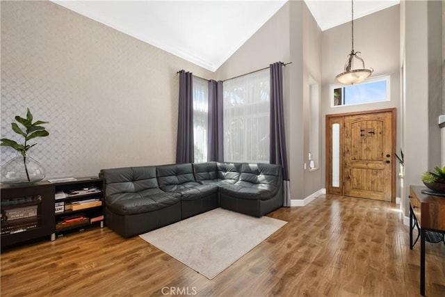 living room featuring plenty of natural light, high vaulted ceiling, and hardwood / wood-style floors