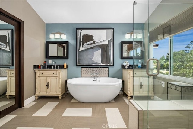 bathroom with tile patterned flooring, vanity, and separate shower and tub