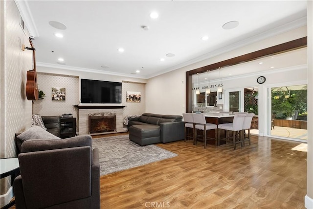 living room featuring wood-type flooring and ornamental molding