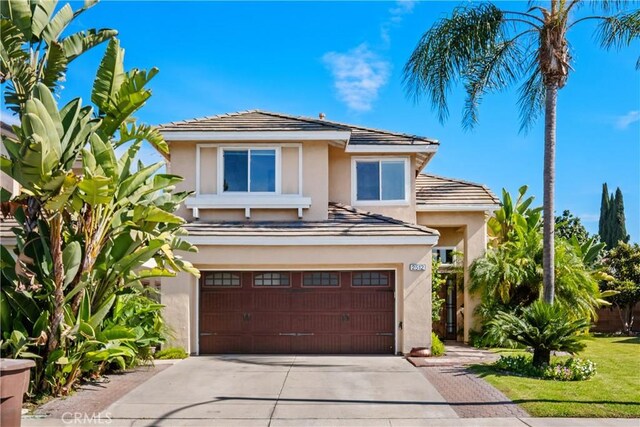 view of front of house with a front yard and a garage